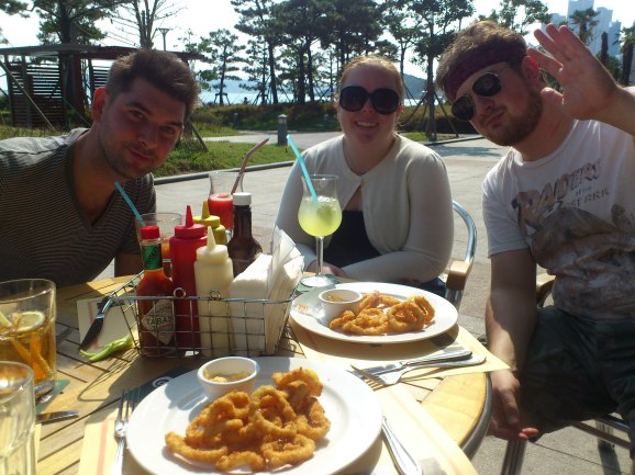 Adam, Heather and Andrew sat in the sunshine outside Geckos, with their amazing calamari. Haeundae, Busan.